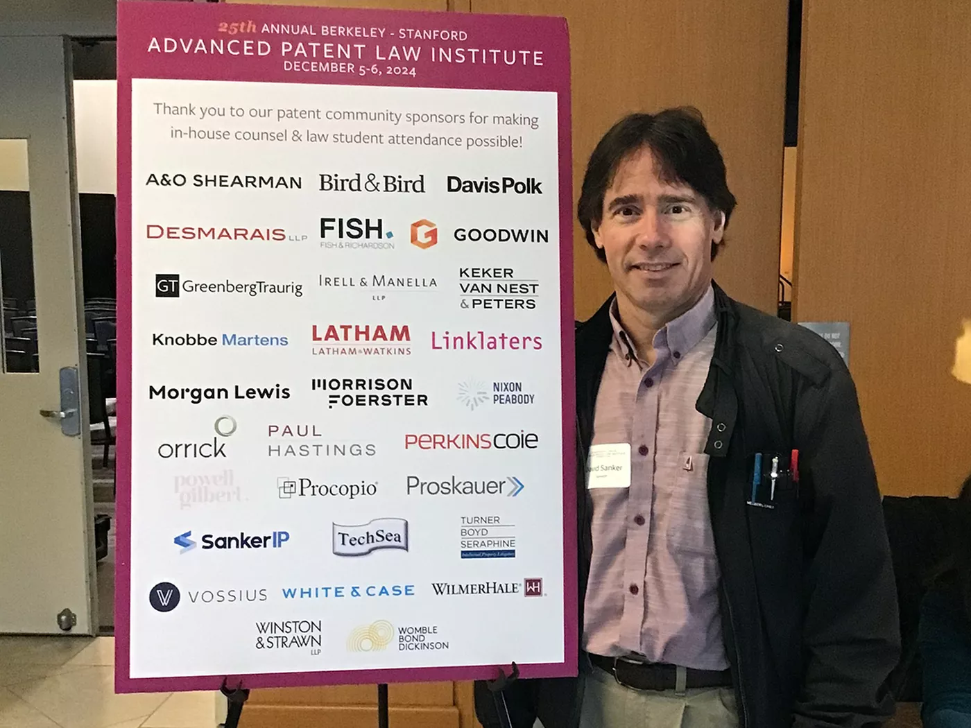 David Sanker standing next to Berkeley-Stanford Advanced Patent Law Institute event.