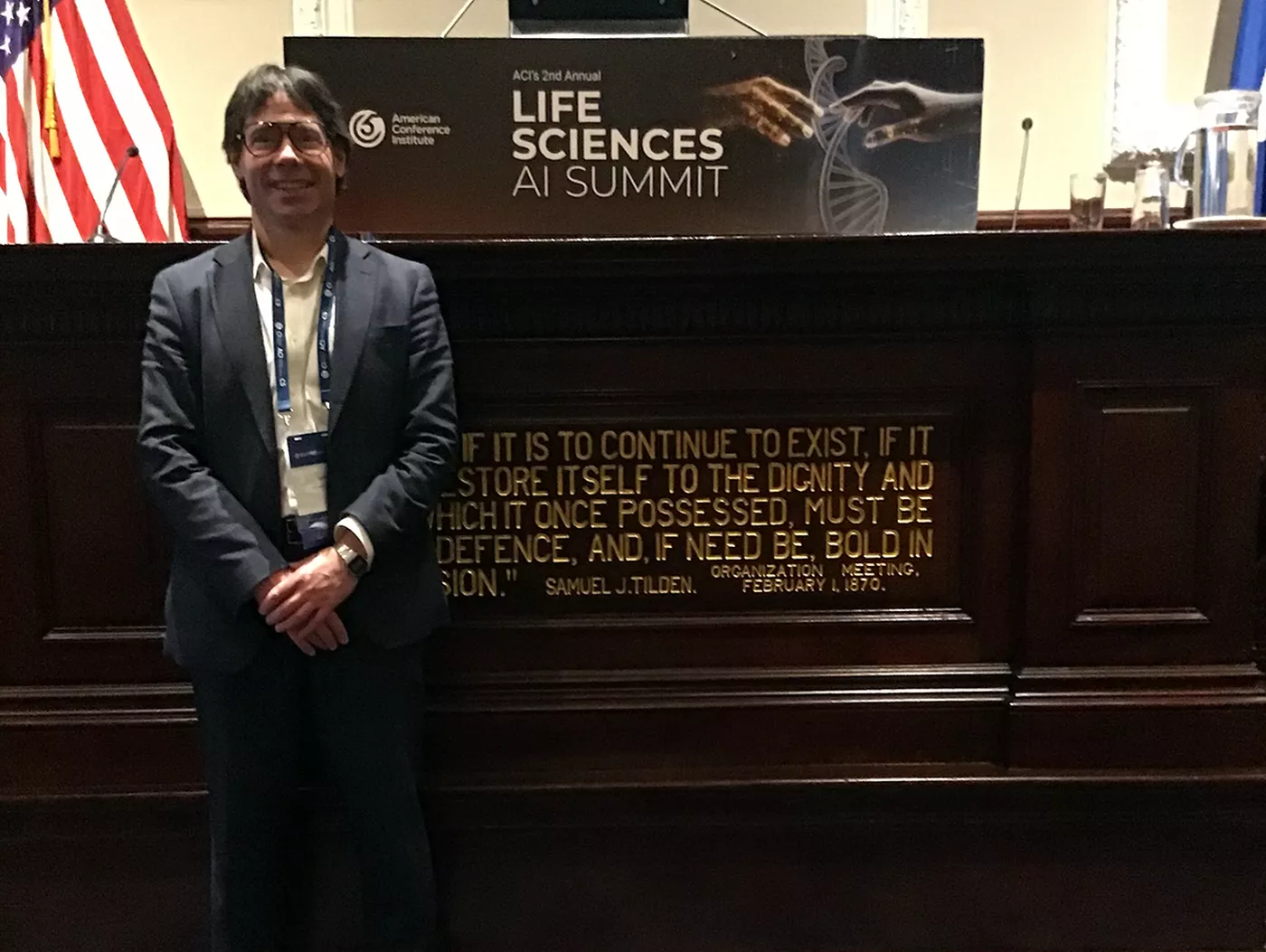 David Sanker standing in front of ACI signage.